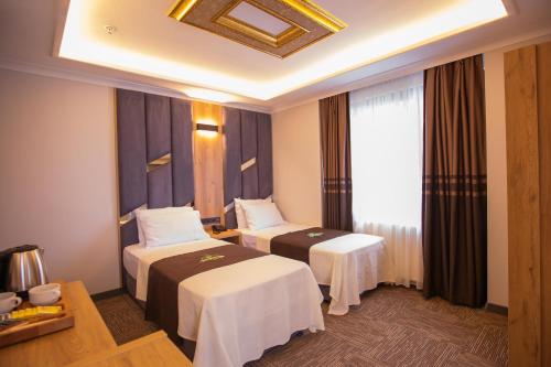 Ένα ή περισσότερα κρεβάτια σε δωμάτιο στο Hotel Milano