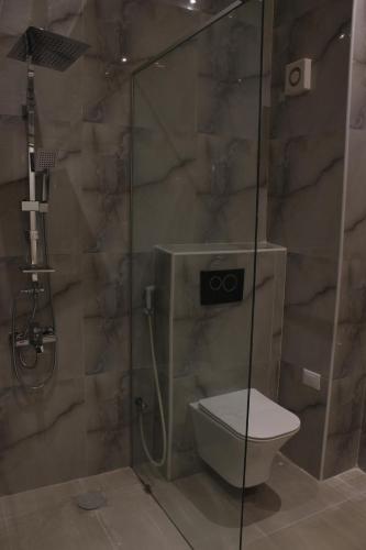 a bathroom with a shower with a toilet in it at Hotel Belle Vie in Kinshasa