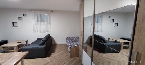 a living room with a couch and a table at A6 Apartment in Kirchardt