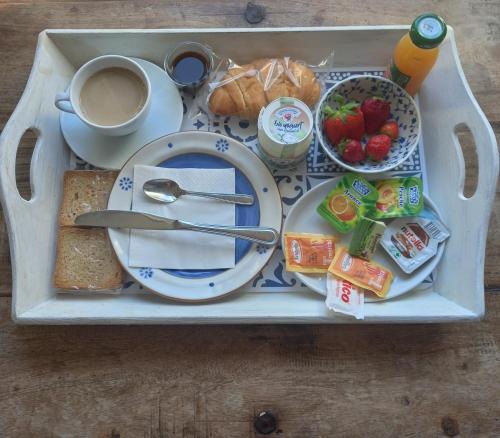 a tray with a plate of food and a cup of coffee at 99 Scalini in Naples