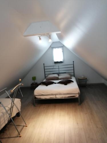 une chambre avec un lit dans un grenier dans l'établissement Appartement 2-3 personnes Saint Cast le Guildo, à Saint-Cast-le-Guildo