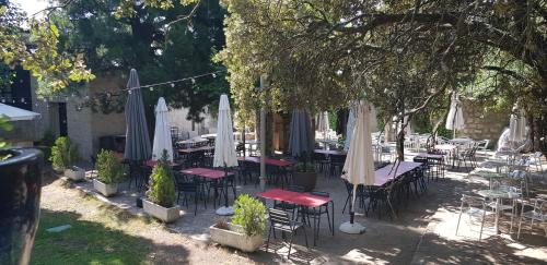 a group of tables and chairs with umbrellas at Hotel Sara De Ur in La Cabrera