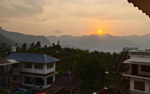 a view of the sun setting over the mountains at Moon Wings Mountain Resort, Kanthalloor in Kanthalloor