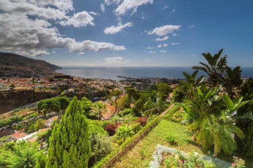 a view of a city with palm trees and the ocean at Quinta Funchal Gardens - Adults Only in Funchal