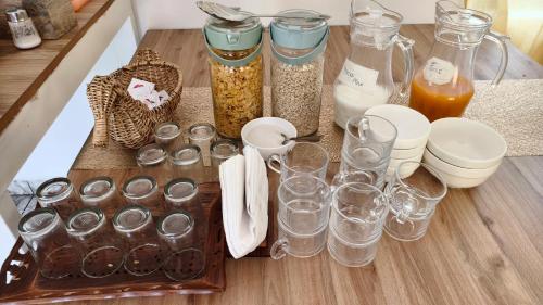 a table with glasses and other items on it at Moon Wings Mountain Resort, Kanthalloor in Kanthalloor