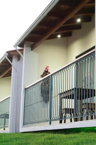 a dog sitting on the balcony of a house at Chalé Alto Serra in Tiradentes
