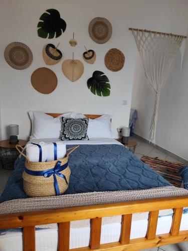 a bedroom with a bed with hats on the wall at Mana mia Seaside Apartments in Leptokaria