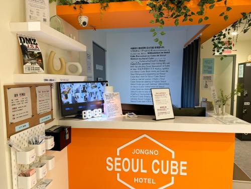 a sign for a seoul cube hotel on a counter at Seoul Cube Jongro in Seoul