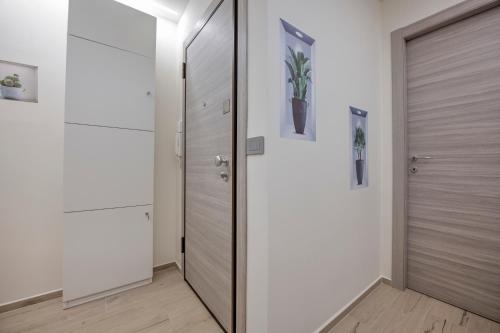 a pivot door in a hallway with white walls at 242 - Camera Est - Affittacamere Sara Home Chiavari, 200Metri dal Mare in Chiavari