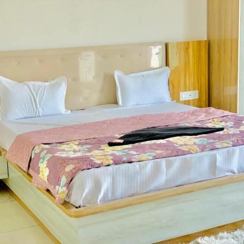 Una cama grande con una manta encima. en THE SILVER TULIP en Ludhiana