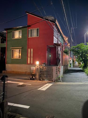 東京的住宿－yiyi tokyo disney minpaku，街上的一座红色和绿色的建筑