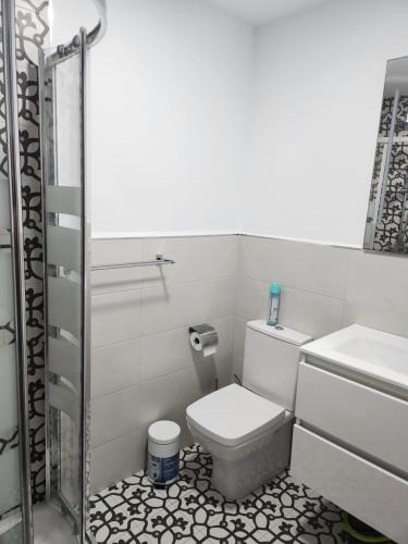 a bathroom with a toilet and a sink at Boomerang in Benidorm