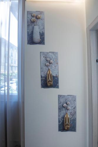 a group of pictures hanging on a wall at 241 - Camera Nord Est - Affittacamere Sara Home Chiavari, 200Metri dal Mare in Chiavari