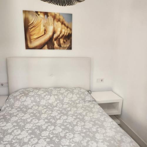 a bedroom with a bed and a picture on the wall at Boomerang in Benidorm