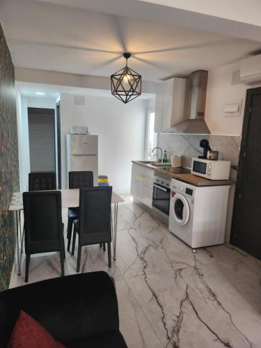a kitchen with a table and a stove top oven at Boomerang in Benidorm