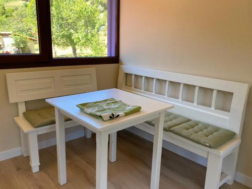 a table and bench in a room with a window at Apartamentos Calm & Nature - Adults Only in Cabezón de Liébana