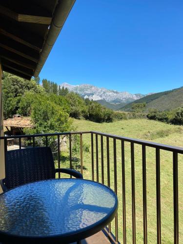 a blue table and chair on a balcony with a view at Apartamentos Calm & Nature - Adults Only in Cabezón de Liébana