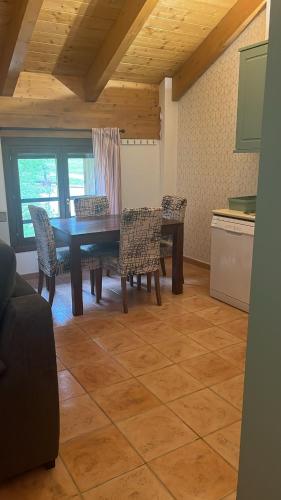 a dining room with a wooden table and chairs at Zara Villanúa in Villanúa