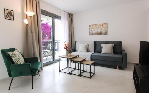 a living room with a couch and a table at Phaedrus Living Skiathos Luxury Residences Gri in Skiathos Town