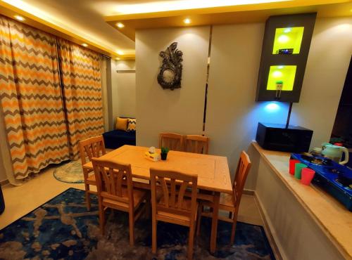 a dining room with a wooden table and chairs at Blue Bay Asia Sokhna Aqua Park for rent O o in Ain Sokhna
