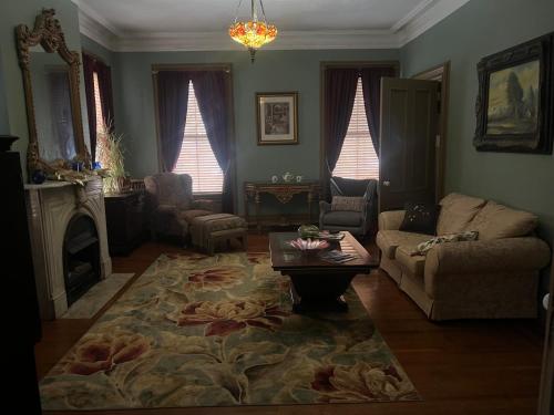 a living room with a couch and a coffee table at 2 Br Victorian Apt 2800 sq ft 2 floors with Full Kitchen 2 baths and Laundry in Poughkeepsie