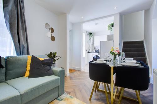 a living room with a couch and a table at Bath Lodge - Arree Stays in Margate