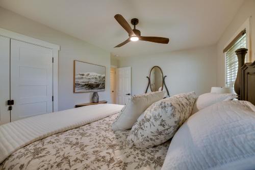 two beds in a bedroom with a ceiling fan at Lake Michigan Getaway Walk to Beach and Golf! in Muskegon