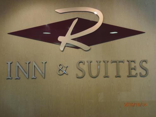a sign for an institution and suites on a wall at Rosslyn Inn & Suites in Edmonton