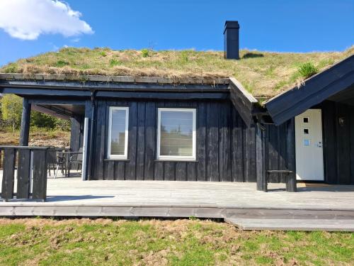 a black building with a grassy hill on the roof at Perfect location at Lifjell in Lifjell