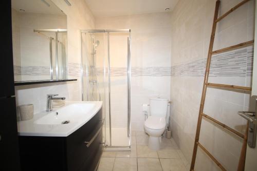 une salle de bain avec toilettes, lavabo et douche dans l'établissement maison 6 personnes proche de la plage, à Canet