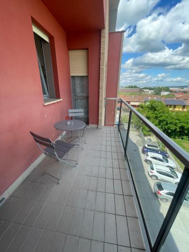 a balcony of a house with a table and chairs at Borgo DiVino in Alba