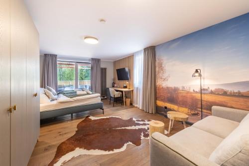 a living room with a large painting on the wall at Resort - D9 in Želnava