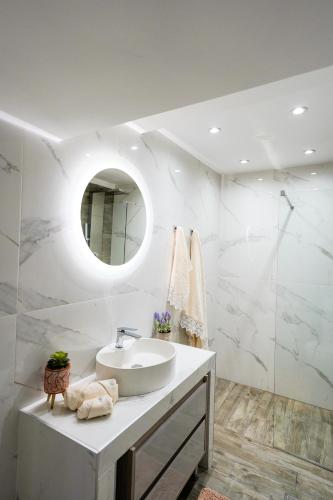 a white bathroom with a sink and a mirror at LOVELY AND SUNNY APARTAMENT 300m FROM BEACH!! in Perea