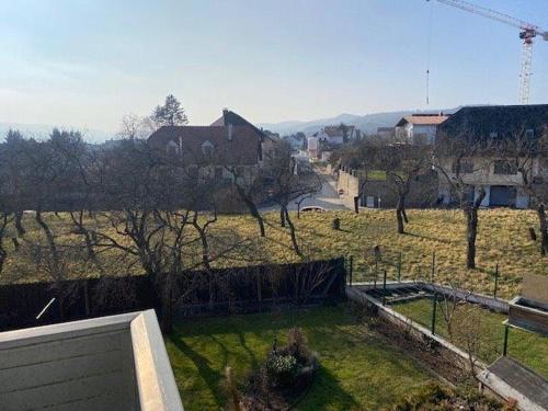 a view of a field with trees and a house at Penthouse Langenloiserberg in Krems an der Donau