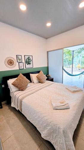 a bedroom with a large bed with a large window at Finca acogedora en Villeta con piscina privada in Villeta