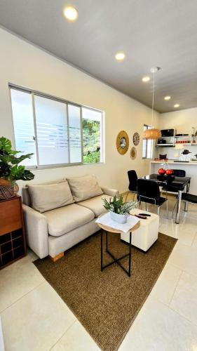 a living room with a couch and a table at Finca acogedora en Villeta con piscina privada in Villeta