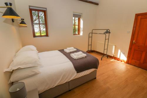 a bedroom with a bed with two towels on it at The Granary in Penzance