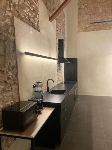 a kitchen with a black counter and a sink at Amazing suite by the fair in Valencia