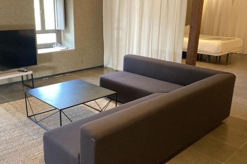 a living room with a couch and a coffee table at Amazing suite by the fair in Valencia