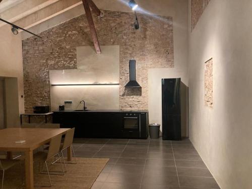 a kitchen with a table and a counter in a room at Amazing suite by the fair in Valencia