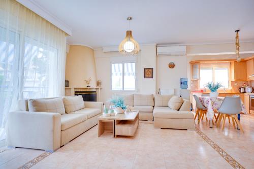 a living room with a white couch and a table at LOVELY AND SUNNY APARTAMENT 300m FROM BEACH!! in Perea