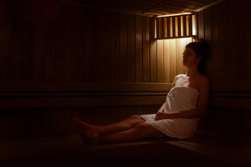 a woman in a towel sitting in a room at Zamek Dubiecko in Dubiecko