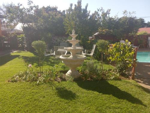 a fountain in the middle of a yard at SONHOS dreams Self catering Garden Cottages in Bloemfontein