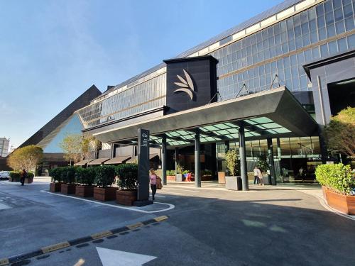 un grand bâtiment avec un bâtiment avec une enseigne devant lui dans l'établissement Parque Jockey by Viva - Prédio com fácil acesso a Pinheiros e ao Butantã, à São Paulo