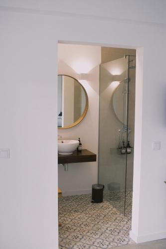 a bathroom with a sink and a mirror at Casa Oliva - Casa da Serra in Porto de Mós