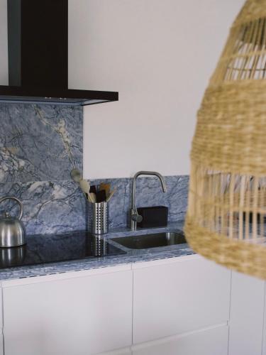a kitchen with a sink and a counter top at Casa Oliva - Casa da Serra in Porto de Mós