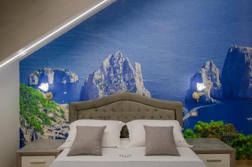 a bedroom with a large mural of mountains at Le 5 Perle in Agerola