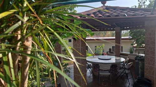 a patio with a table and chairs under a pergola at Villa Garita Inn in La Garita