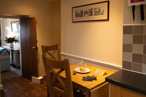 a kitchen with a table with a plate of food on it at The Peacock at Barlow in Chesterfield