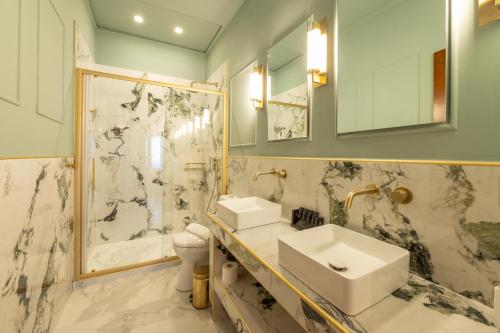 a bathroom with a sink and a shower at L Suites The Writer's House in Gythio